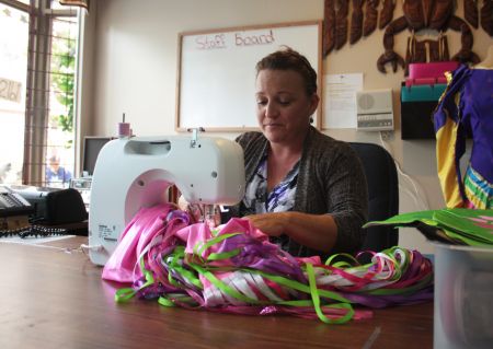 Donna, at the Mi'kmaq daycare, sews a child's pink skirt. Photo by Hilary Beaumont