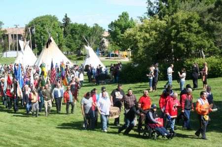 After lighting the sacred fire that will burn throughout the TRC national event in Saskatoon, residential school survivors, their families, the Commissioners and others walked to the opening ceremonies. Photo: Sandra Cuffe