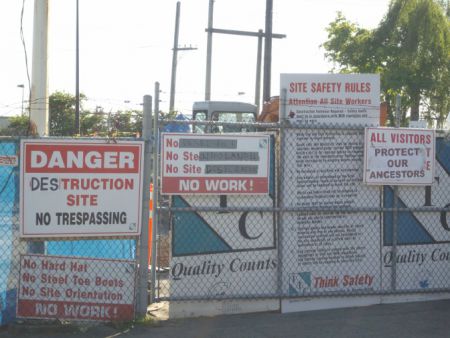 Altered construction signs reflecting the purpose of blockade.