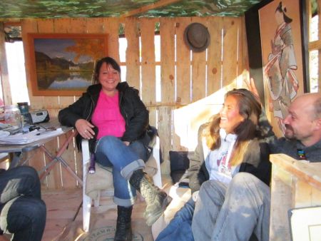 Nicole, Ester and Bruce occupying their newly constructed cabin in the Safe Zone.  Some occupiers hope to construct more permanent structures in the days to come inspite of possible eviction.