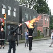 Festive rally holds/blocks 12th & Clark - symbolic burning of 2010Olympic propaganda