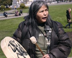 Rose playing a native drum at a homeless rally at the Legislature, April 2009//Pete Rockwell 