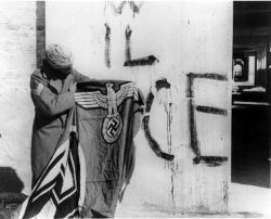 Bringing Freedom to the world - A Sikh soldier of the 11th Sikh Regiment with a captured Nazi flag in Italy at the end of the Second World War.