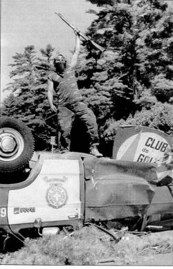 Warrior atop police vehicle, Kanehsatake / Oka Crisis 1990, photo by Tom Hanson, Canadian Press