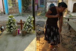 Mariano's partner Mirna Abarca sweeps his gravesite in Chicomuselo, Chiapas