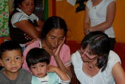 Grandma Donia seen here telling her story through tears. She is raising these two boys after their father went missing.