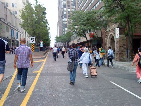 People wandering around on a nearly-car-free Yonge St. after the protest