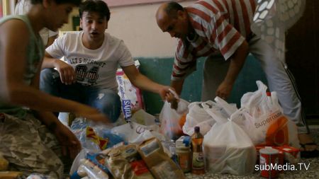 Kurdish immigrants sort donations made by an Athens solidarity group