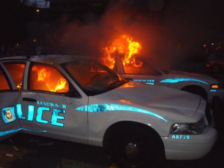 Two cops cars up in flames, June 15, 2011