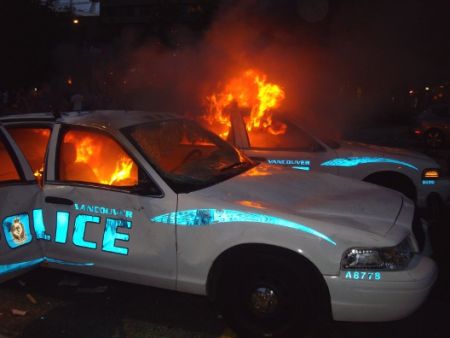 Vancouver police vehicles burn during Canucks Riot, June 15, 2011