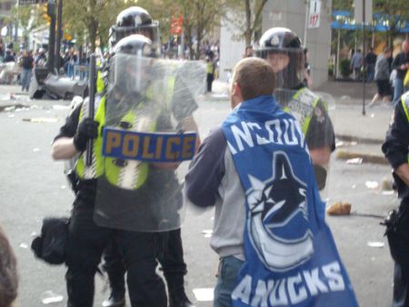 Captain Canuck confronts riot cops June 15, 2011