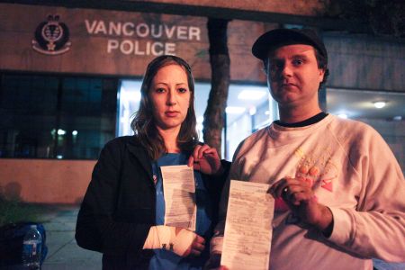 Sasha Wiley-Shaw and Peter Haywood display their charge sheets after their release. Photo by David P. Ball