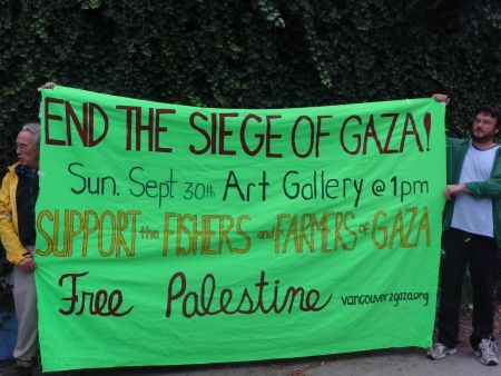 Local activists display banner and plan Sunday rally against Israeli attacks on Gaza fishers and farmers