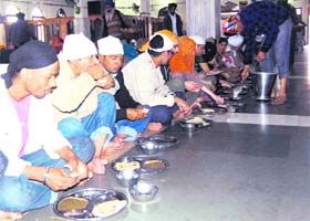 The langar hall (community kitchen) at the Golden Temple. To further the concept of an equal and  harmonious multifaith and multicultural  society, the Sikh Gurus created the concept of langar or community kitchen. The langar is a place where people from all walks of life are welcome to sit together and share a common meal.  
