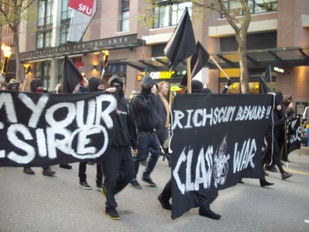 Members of the black bloc and their banners.