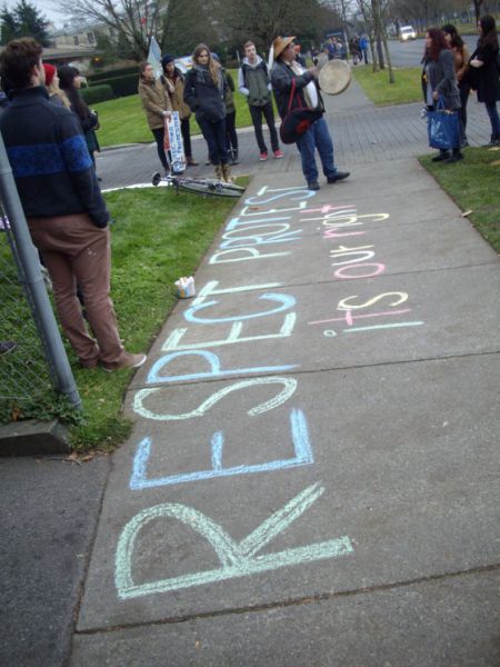 Chalk graffitti requesting the RCMP to "respect our right to protest."