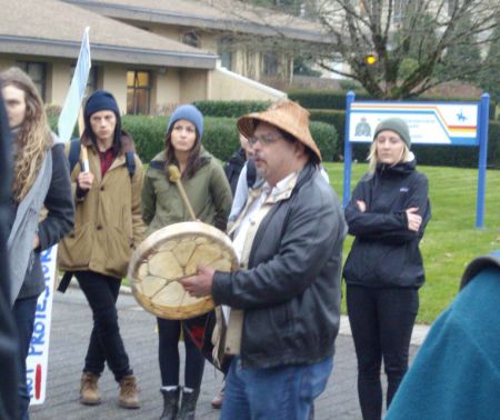 Musqueam singer outside UBC RCMP station.