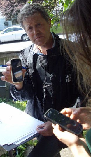 VPD detective constable Rainey holding a phone stolen by cops during June 3, 2014 raid.