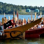 Canoes arrive at Whey-Ah-Wichen - Kinder Morgan pipeline facility in backround