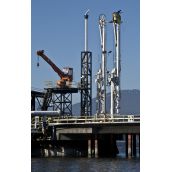 Greenpeace members atop a Kinder Morgan dockside oil pump