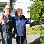 Former neighbours brother and sister Ken and Debbie with the holly bush Debbie planted 40 years ago. 