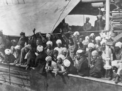 Sikhs on board the Komagata Maru. Many with their hands held high above their heads celebrating arrival in Canada.